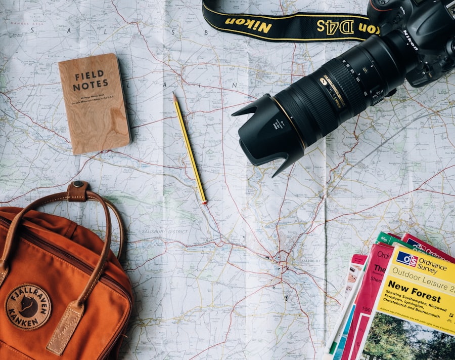 Travel planning map, camera, and notebook